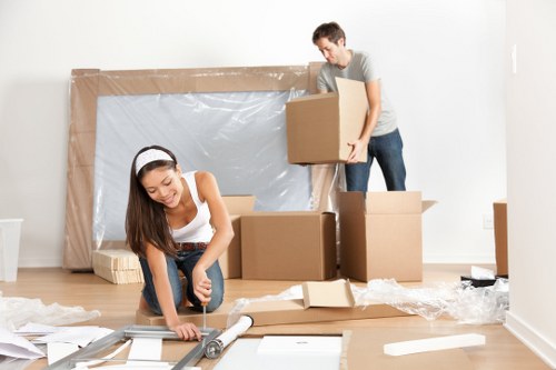 Removal van and moving boxes in a Scottish residential street