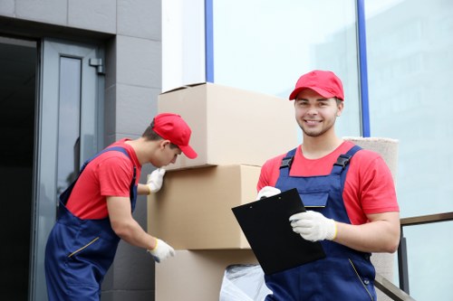 Removal team carrying furniture safely with protective equipment